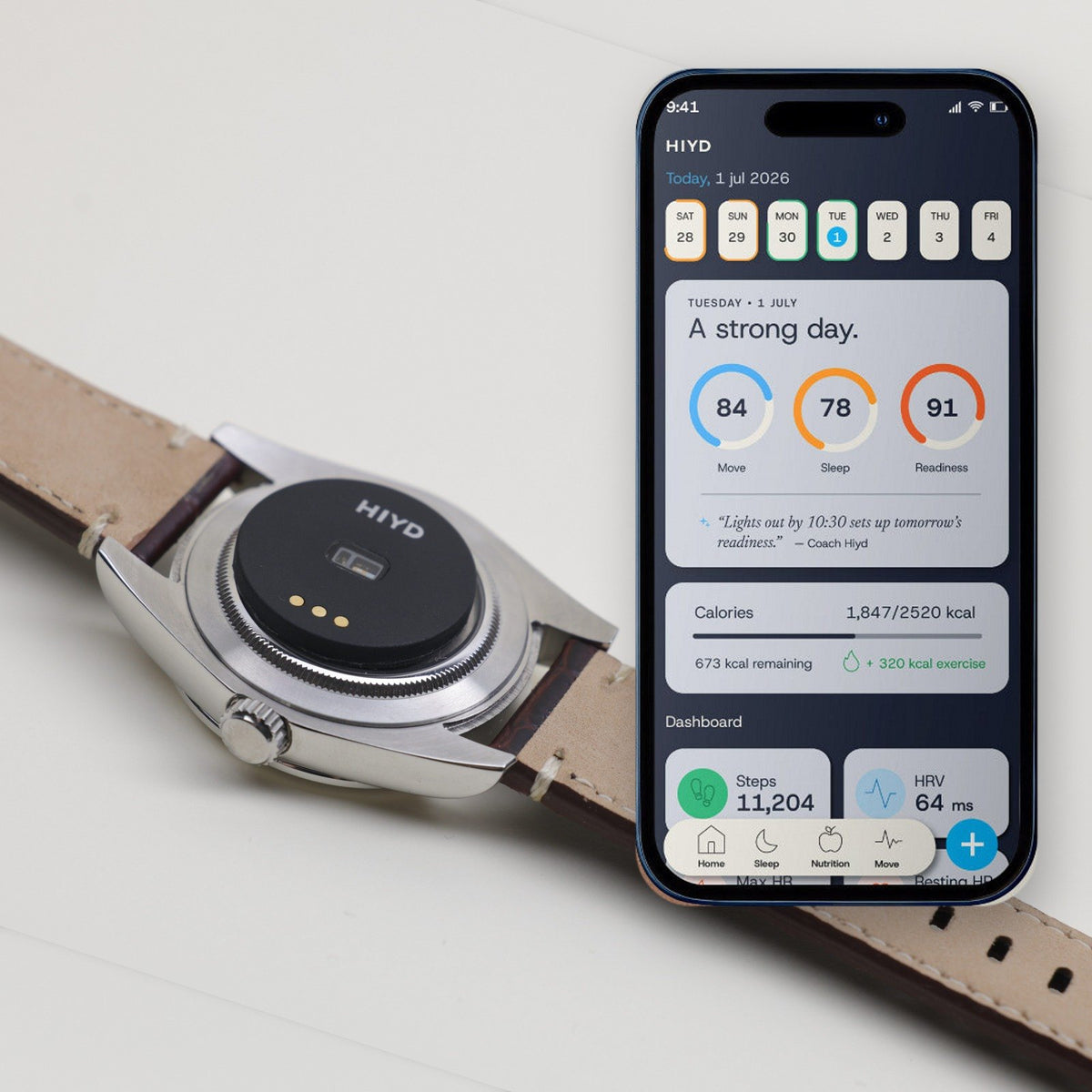 A steel watch turned over with the HIYD sensor on its caseback, beside a phone showing the HIYD app