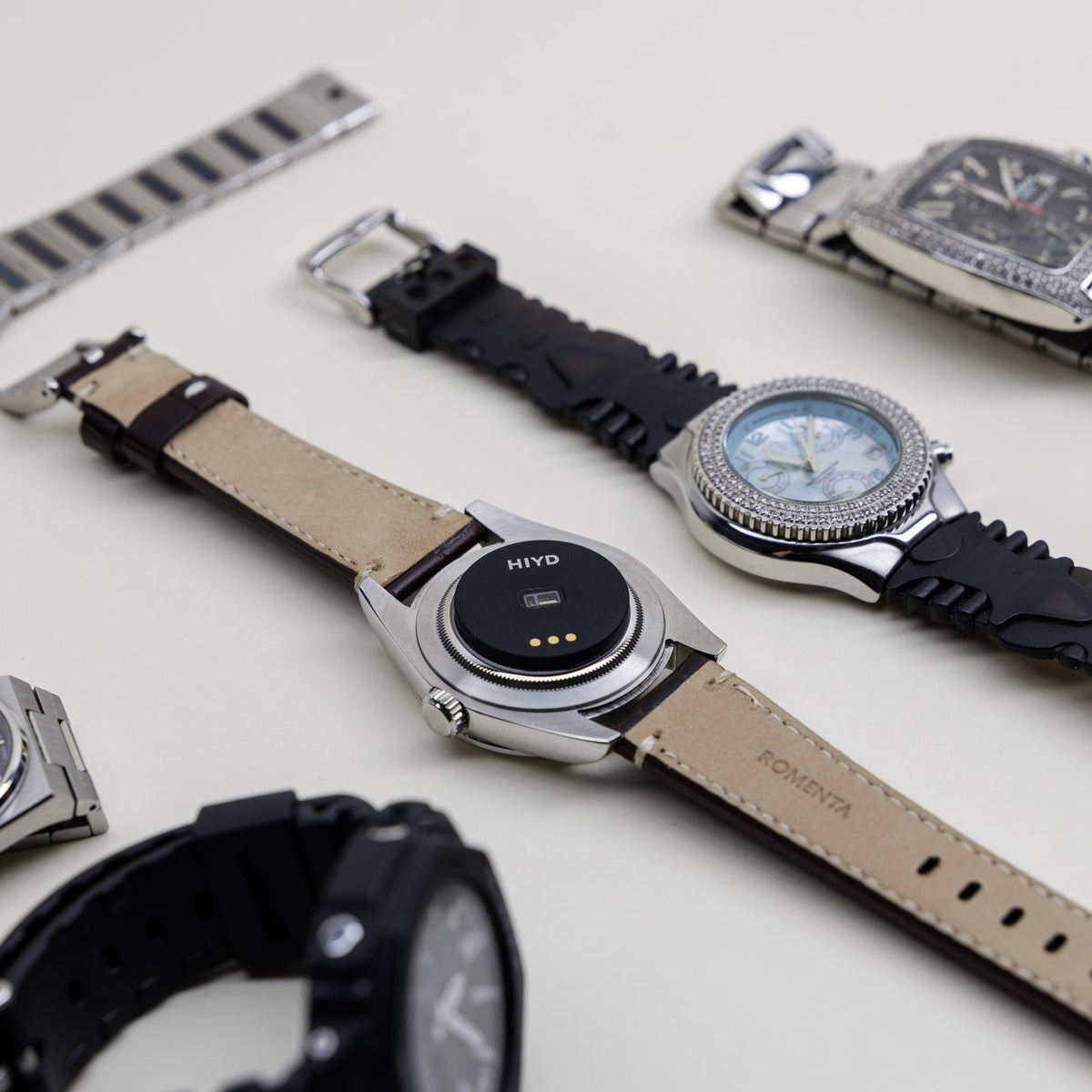 A spread of watches in different styles, one turned over with the HIYD sensor fitted